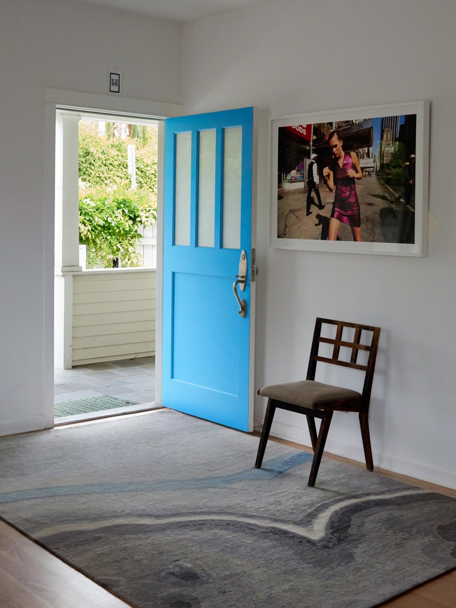 Apache Rug from Geode Collection displayed in home entrance with a blue door 