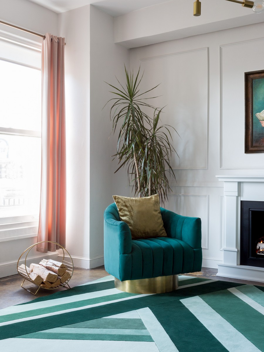 Mint colored Geometric rug paired with green chair in a living space 