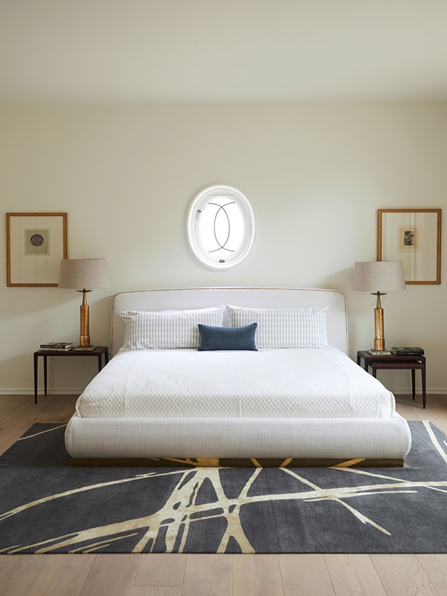 White bed with Navy and Gold Calypso rug from Transitional collection