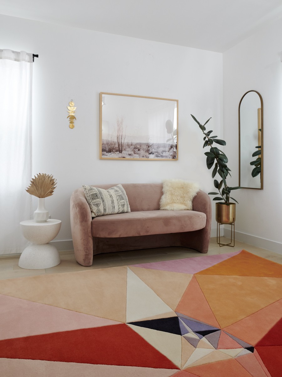 Pink couch with abstract inspired rug by Karim Rashid