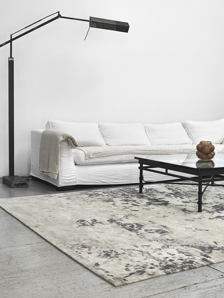 West Berlin rug displayed in a modern neutral toned living space with white couch 