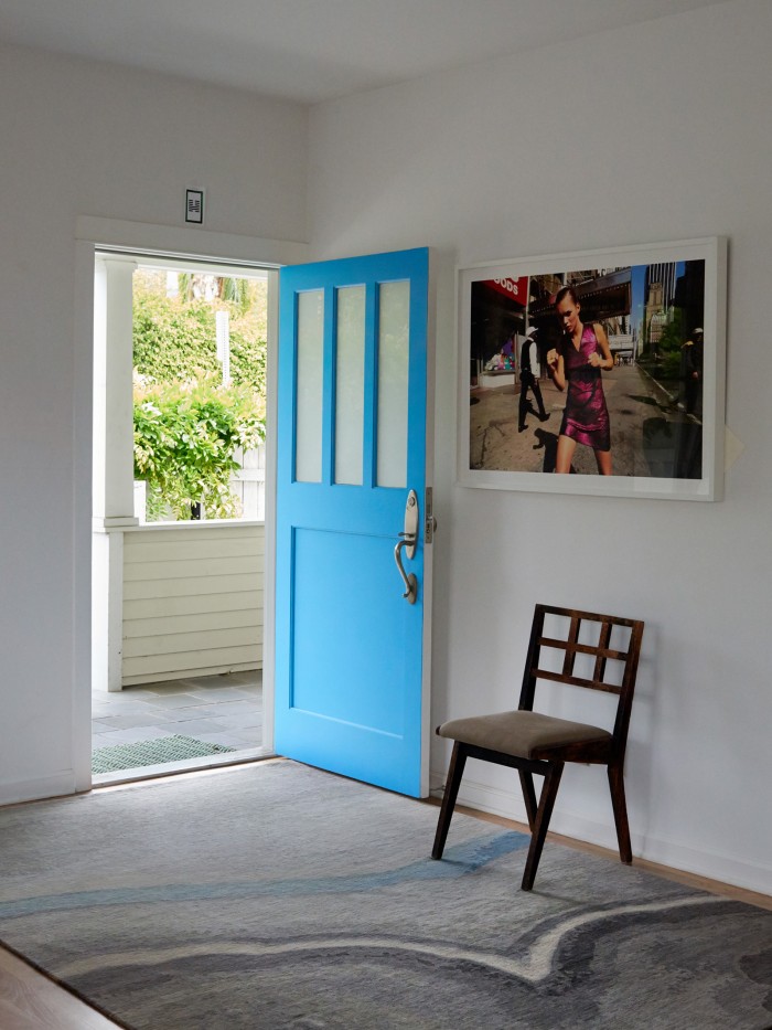 Apache Rug from Geode Collection displayed in home entrance with a blue door 