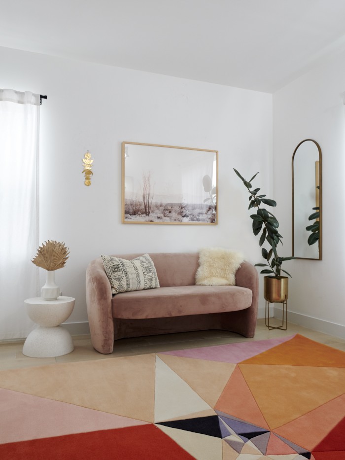Pink couch with abstract inspired rug by Karim Rashid 