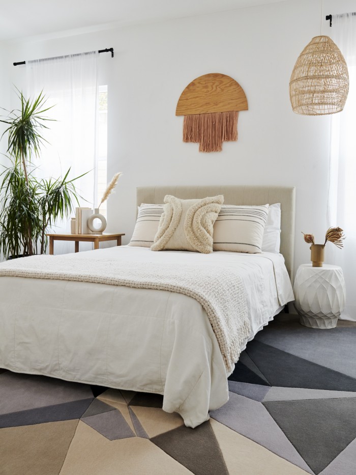 Neutral toned bedroom with Geometric rug by Karim Rashid 